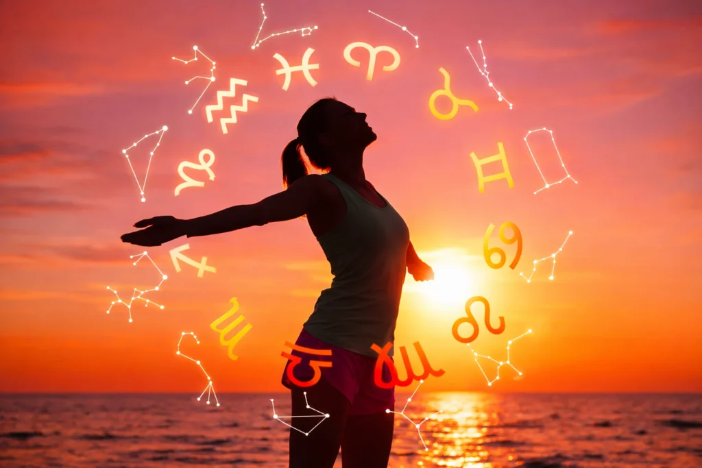 Representación de la astrología con los signos del zodiaco y constelaciones alrededor de una figura femenina al atardecer